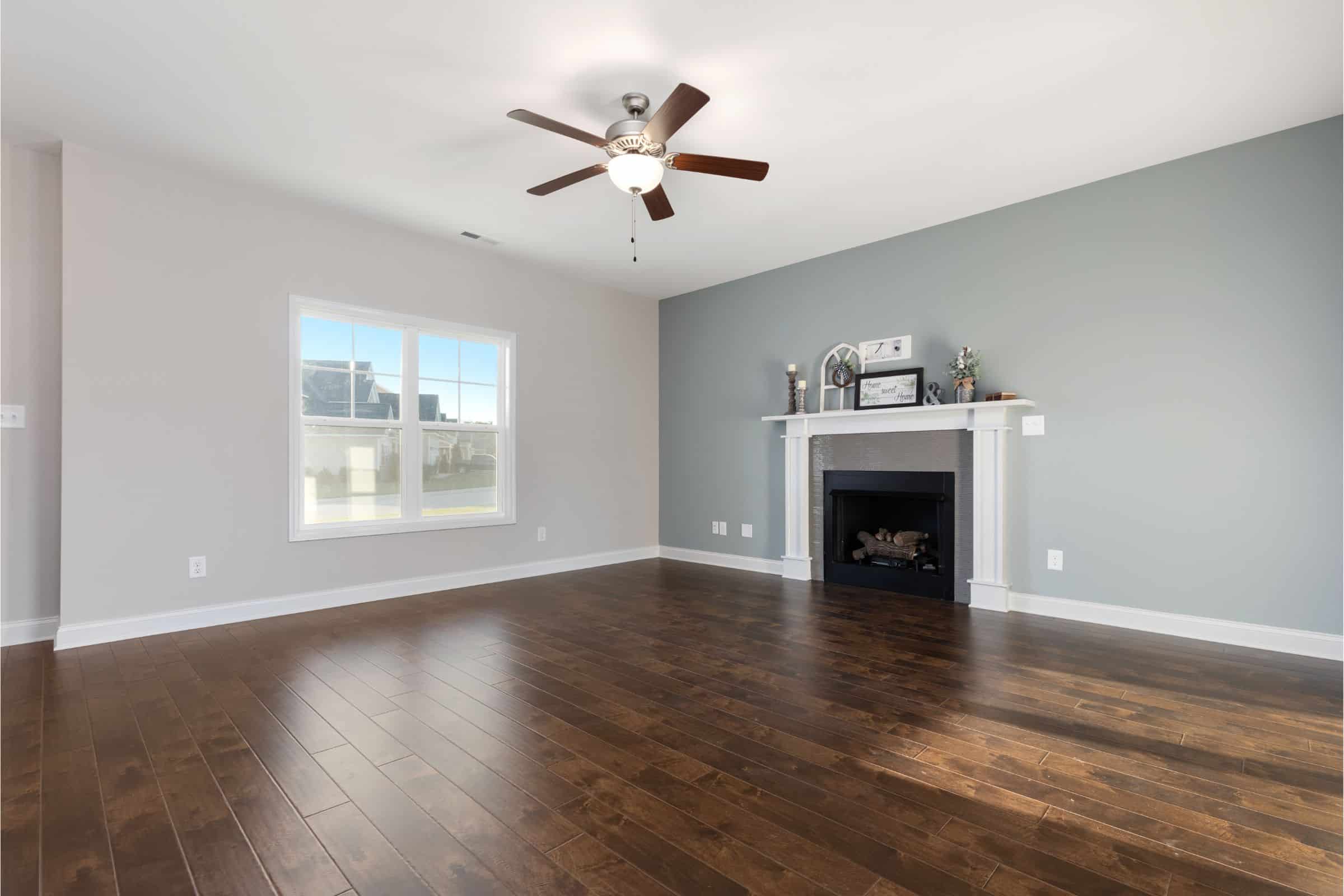Empty Living room with dark wood floors and fireplace