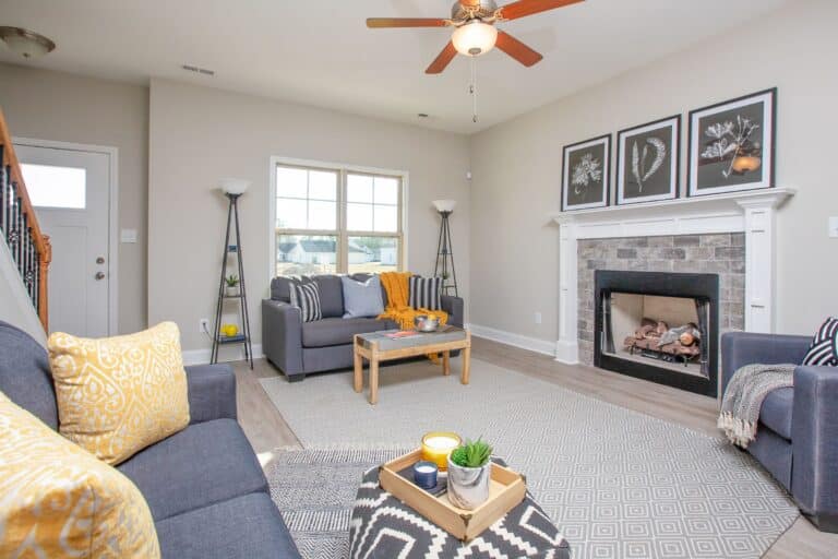 Staged Living Room with Blue couches and fireplace